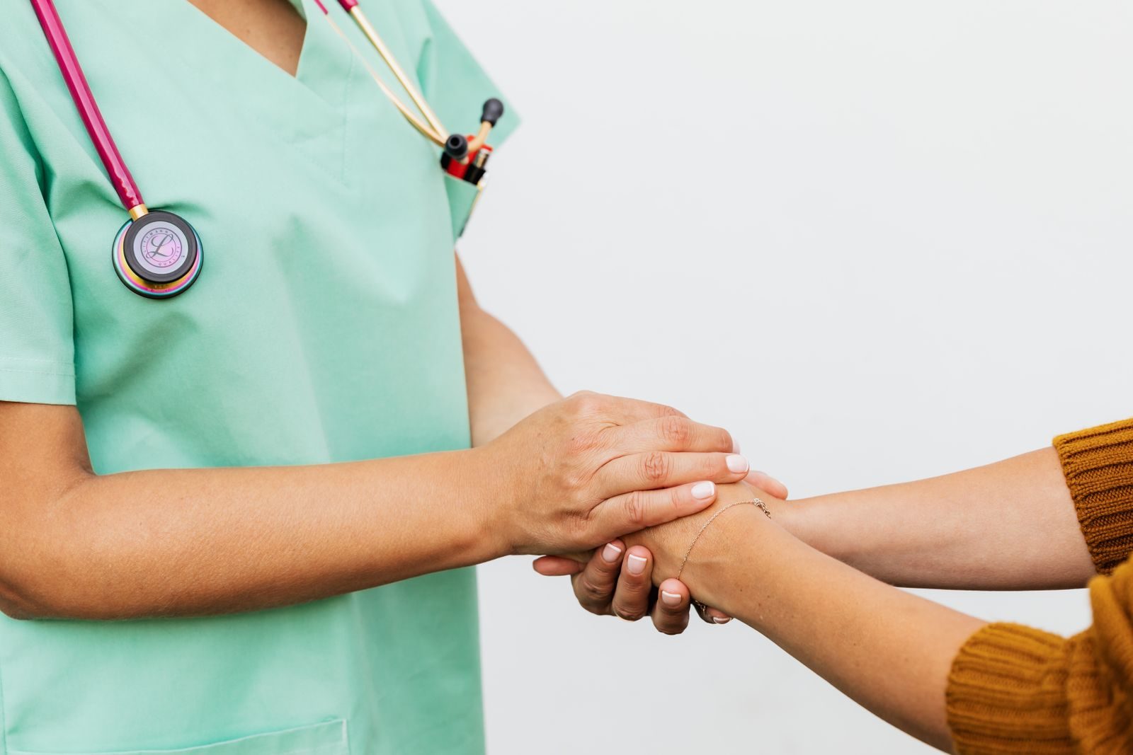 Close-up of a doctor holding a patient's hands, symbolizing trust and empathy in healthcare.