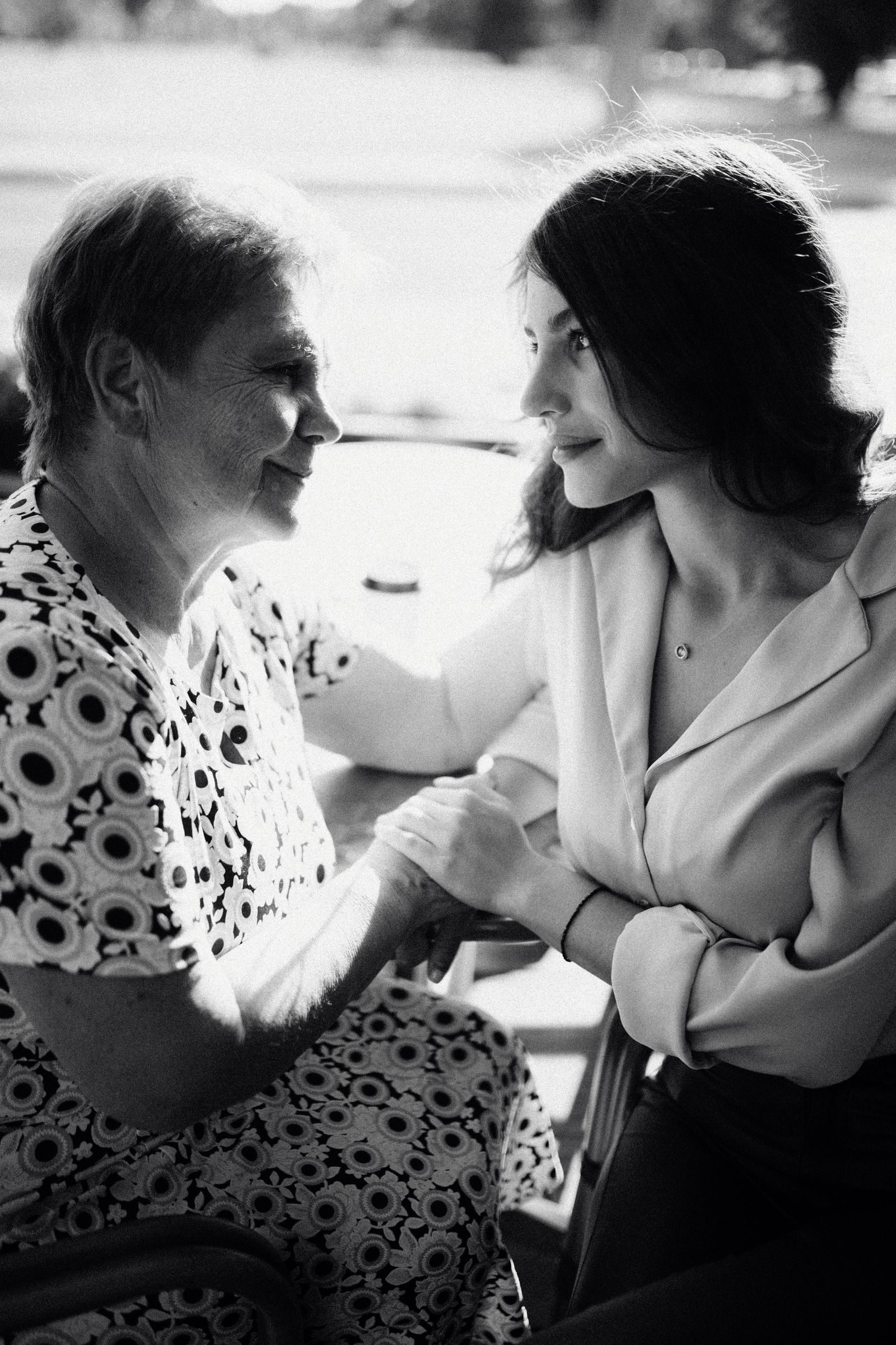Emotional black and white portrait of a mother and daughter sharing a tender moment.