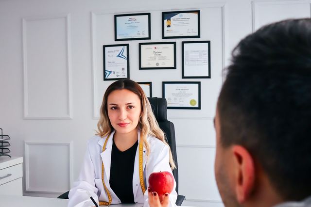 A nutritionist advises a client about healthy eating in a modern office with fruits.