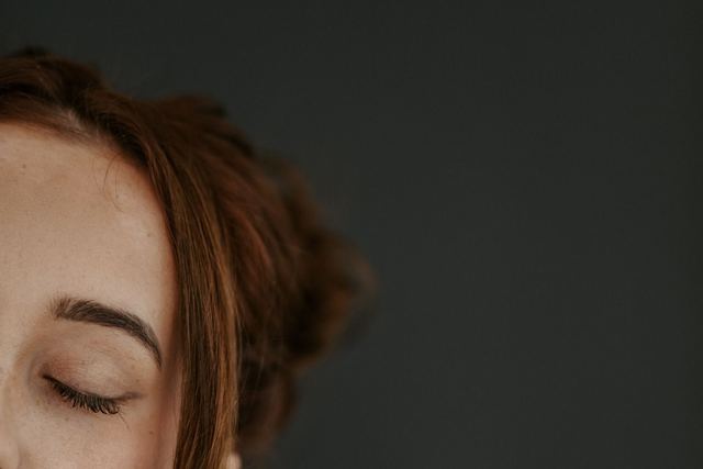 Intimate portrait of a woman with closed eyes, serene expression.