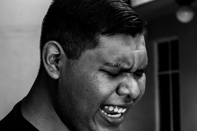 Dynamic black and white portrait of a singer passionately performing outdoors.