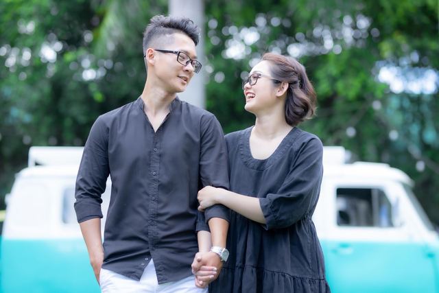 Asian couple sharing a joyful moment outdoors. Captured with Canon EOS 6D Mark II.