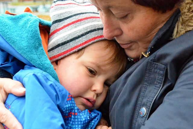 A tender moment of love and affection between a grandmother and her grandchild outdoors.