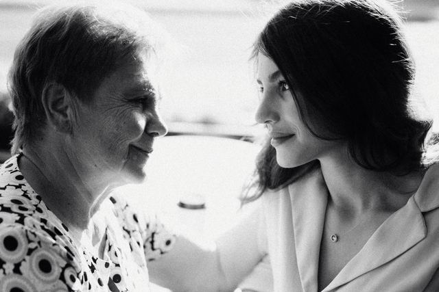 Emotional black and white portrait of a mother and daughter sharing a tender moment.