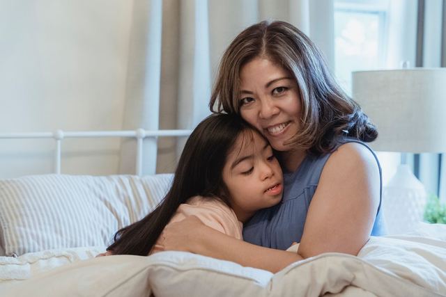 A warm embrace between mother and daughter in a cozy indoor setting, capturing affection and love.